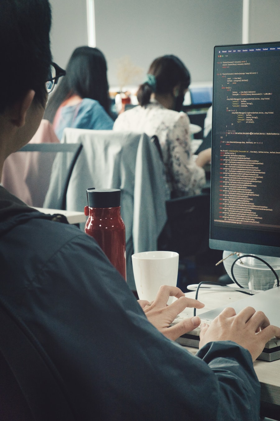 A person building their own website on a laptop, fully focused on the work.