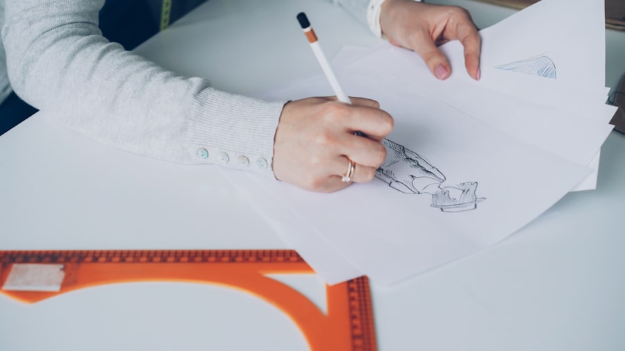 A designer sketching a website layout by hand while weighing design options