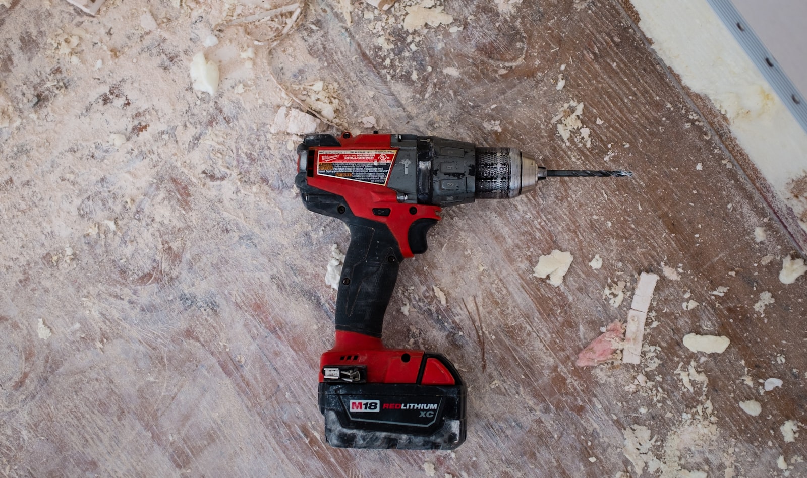 A well-worn cordless drill on a job site, still doing the work
