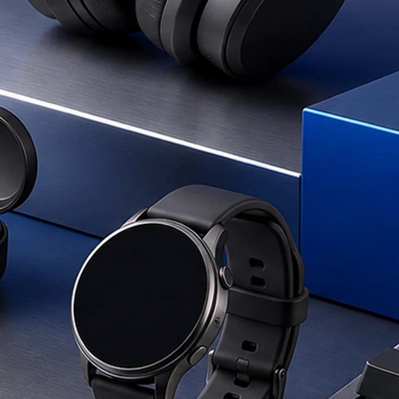 Fictional graphite smartwatch on a brushed-metal plinth