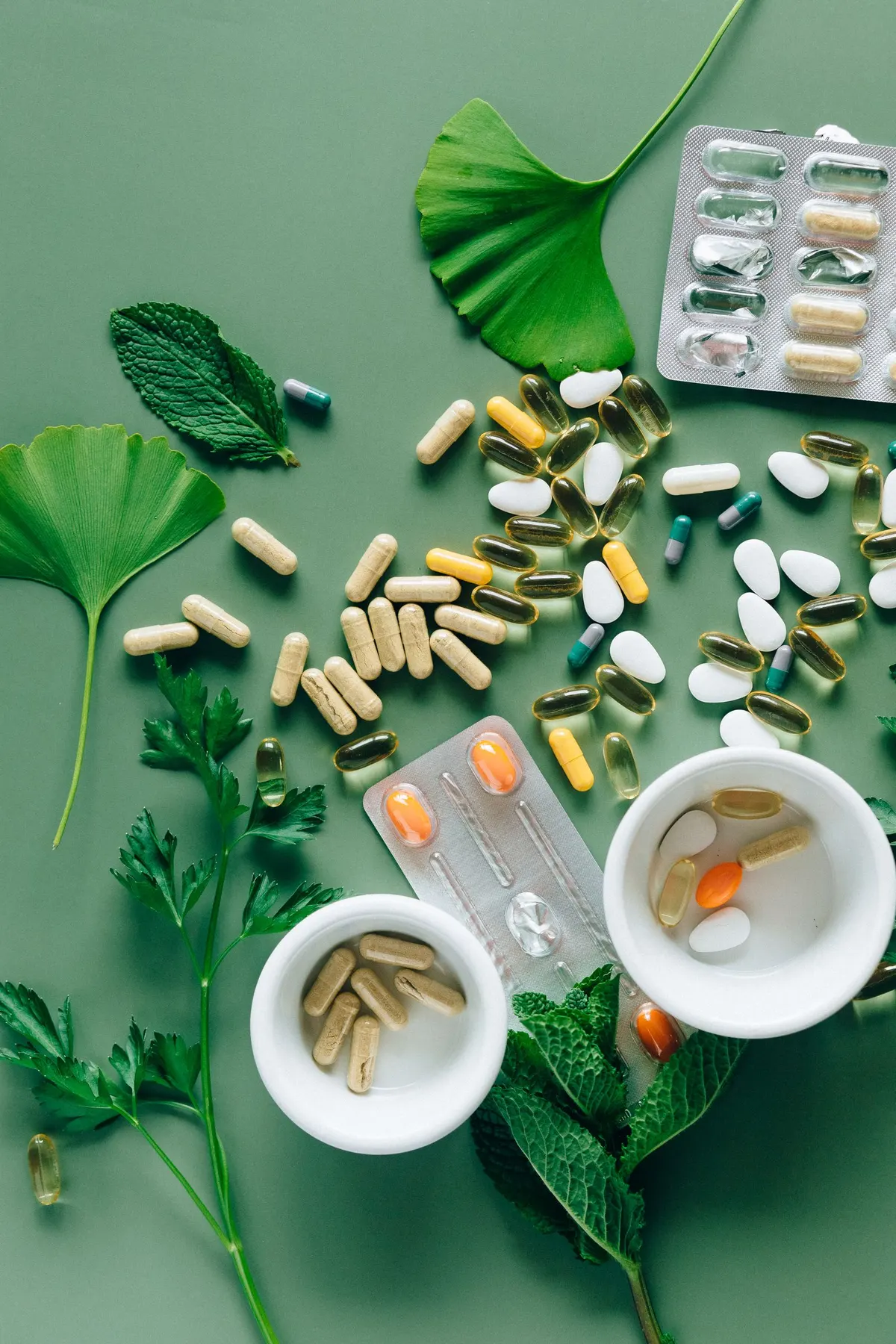 A flat lay of assorted supplement capsules and herbs