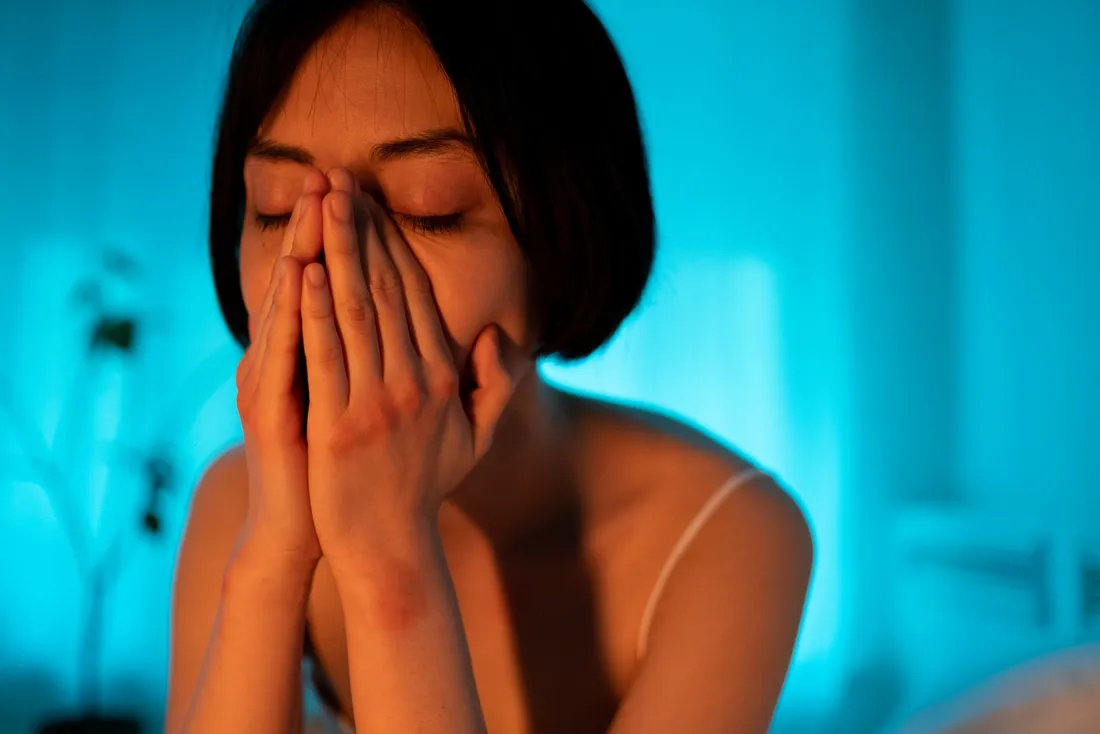 A woman relaxing in her bedroom in the evening